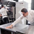 How do you clean commercial kitchen surfaces?